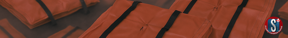Stacked orange stormwater grate guard mats with black straps arranged on an industrial surface, representing Skookum Tools’ drain protection and sediment control products for spill containment and stormwater management.