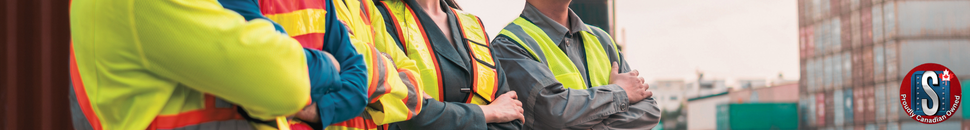Workers wearing high-visibility vests and safety gear standing with arms crossed at an industrial site, representing Skookum Tools’ general safety wear and protective equipment category.